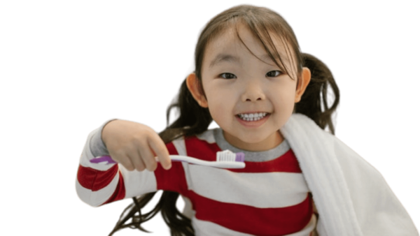 child smiling while holding a toothbrush 